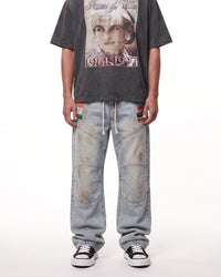 Triple Sevens Moto Denim Pants blue, waist-down front view on model showing the light-wash denim and patches
