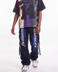 Hellstar Printed Cargo Pants black, waist-down front view on model showing the white tribal Hellstar lettering