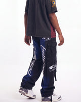 Hellstar Printed Cargo Pants black, waist-down rear view on model showing the blue spray fade and leg lettering