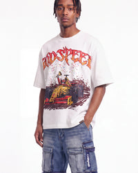 A man wearing a white graphic t-shirt with a red and yellow 'RDSPEECH' logo and a race car illustration, paired with blue cargo pants, against a plain white background.