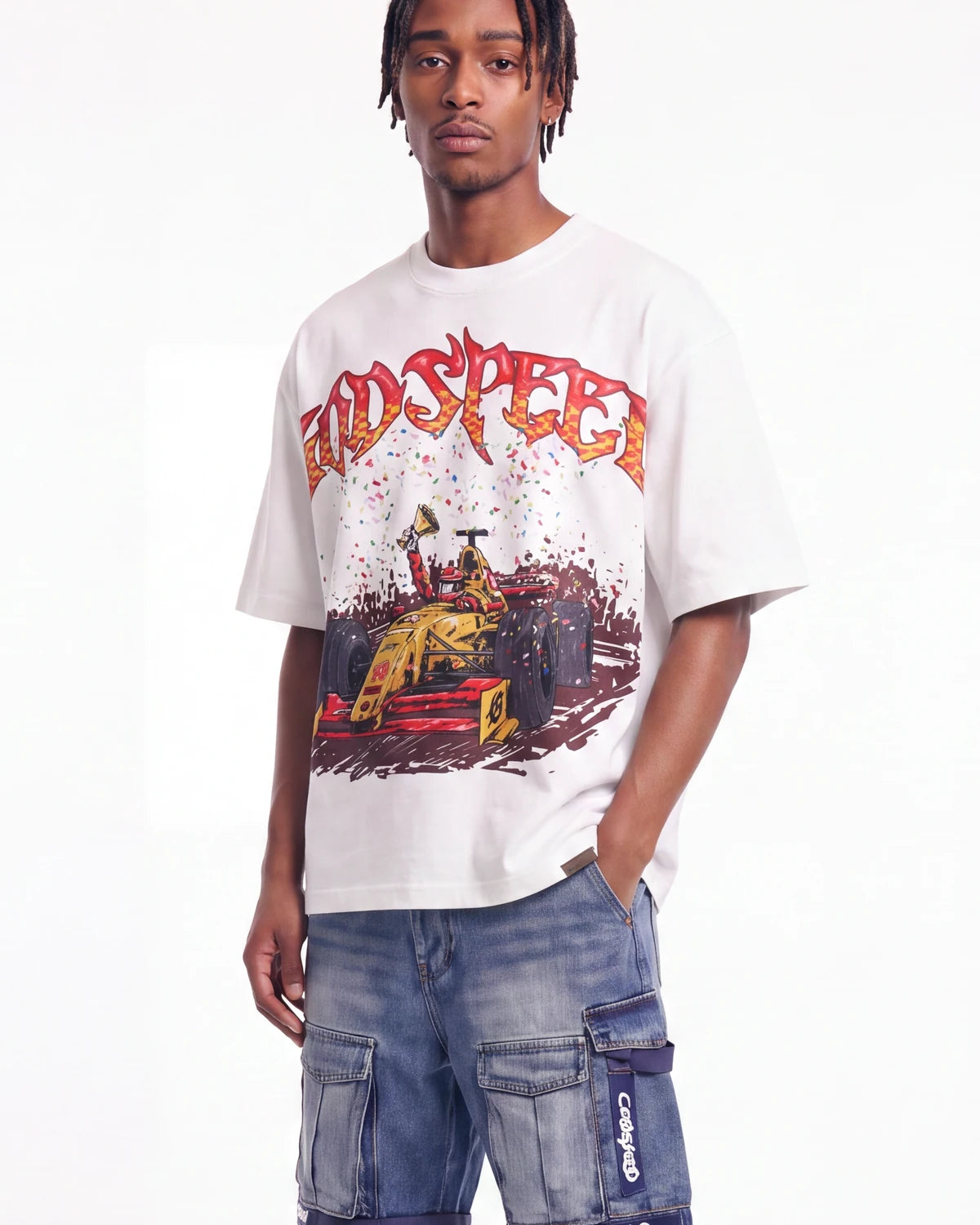 A man wearing a white graphic t-shirt with a red and yellow 'RDSPEECH' logo and a race car illustration, paired with blue cargo pants, against a plain white background.