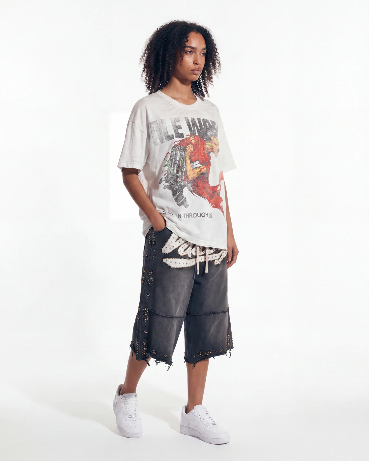 Restock AR Outfit #38, washed white graphic tee styled with studded baggy black denim shorts, full look