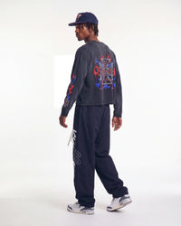 HMDD RWB 4th L/S Tee black worn with Vale Forever Midnight Swish track pants, rear three-quarter view on model