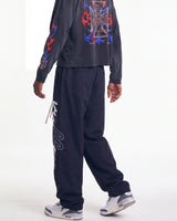 Vale Forever Midnight Swish Track Pants black, worn on model with the white Valley script visible down the leg