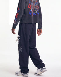 Vale Forever Midnight Swish Track Pants black, worn on model with the white Valley script visible down the leg