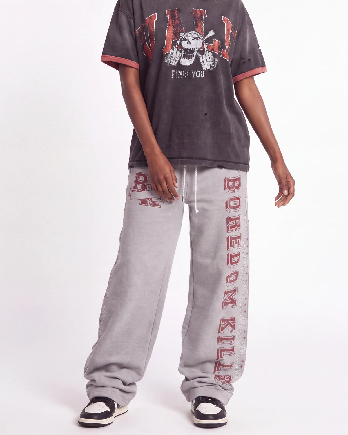Boredom Kills Collegiate Sweats grey and red, waist-down front view on model showing the red collegiate lettering