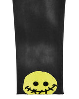 All Human Deli Set V2 Sweatsuit black wash, close-up of the stitched smiley patch on the pant leg