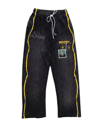 All Human El Cielo Sweatpants black wash, washed black cotton fleece pants with yellow side piping and ALL HUMAN lettering, front view
