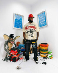 All Human El Cielo Sweatpants black wash, worn on model with a cream All Human motocross graphic tee