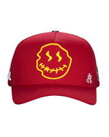 All Human Human After All V2 Trucker Hat Red, red mesh trucker with a large yellow stitched-mouth smiley, front view