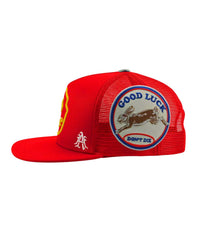 All Human Human After All V2 Trucker Hat Red, close-up of the embroidered side panel