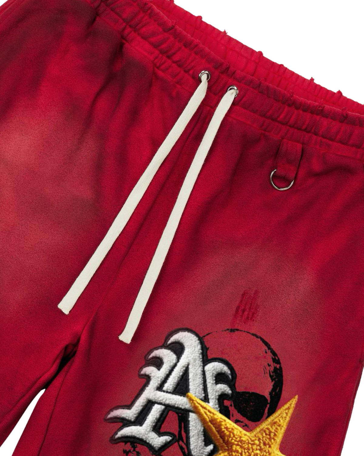 All Human Mars Shorts red, close-up of the drawcord waist and embroidered gold star