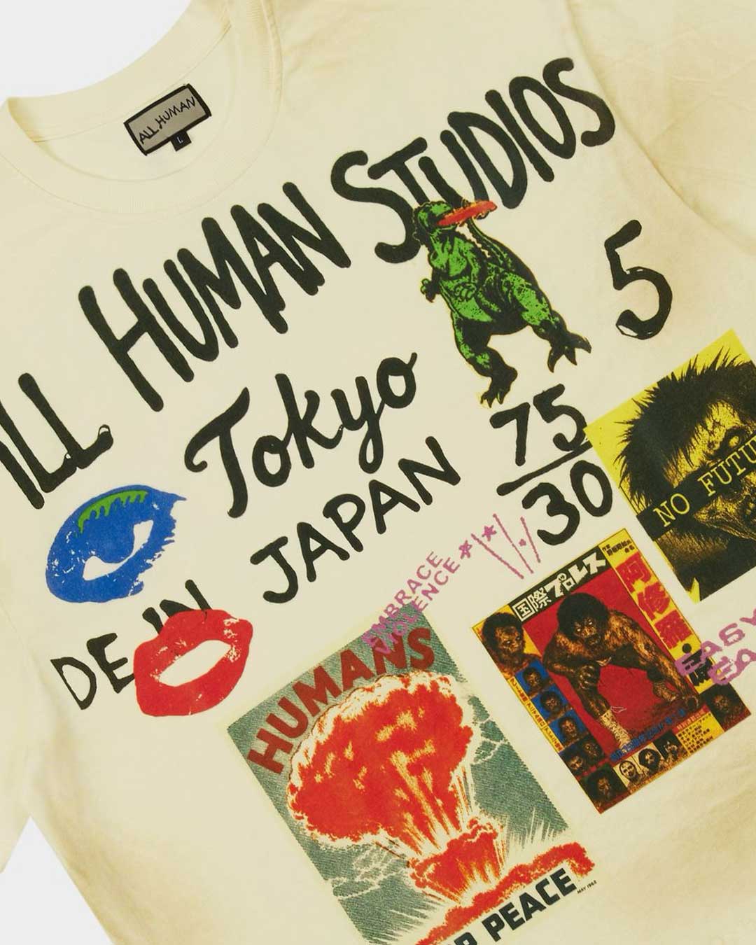 All Human Shinjuku Tee cream, close-up of the front Tokyo graphic with the green kaiju and NO FUTURE poster clipping