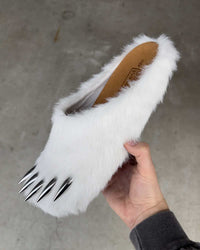 Bravest Studios Bear Claw Mule white furry slip-on with claw detailing, model holding the shoe