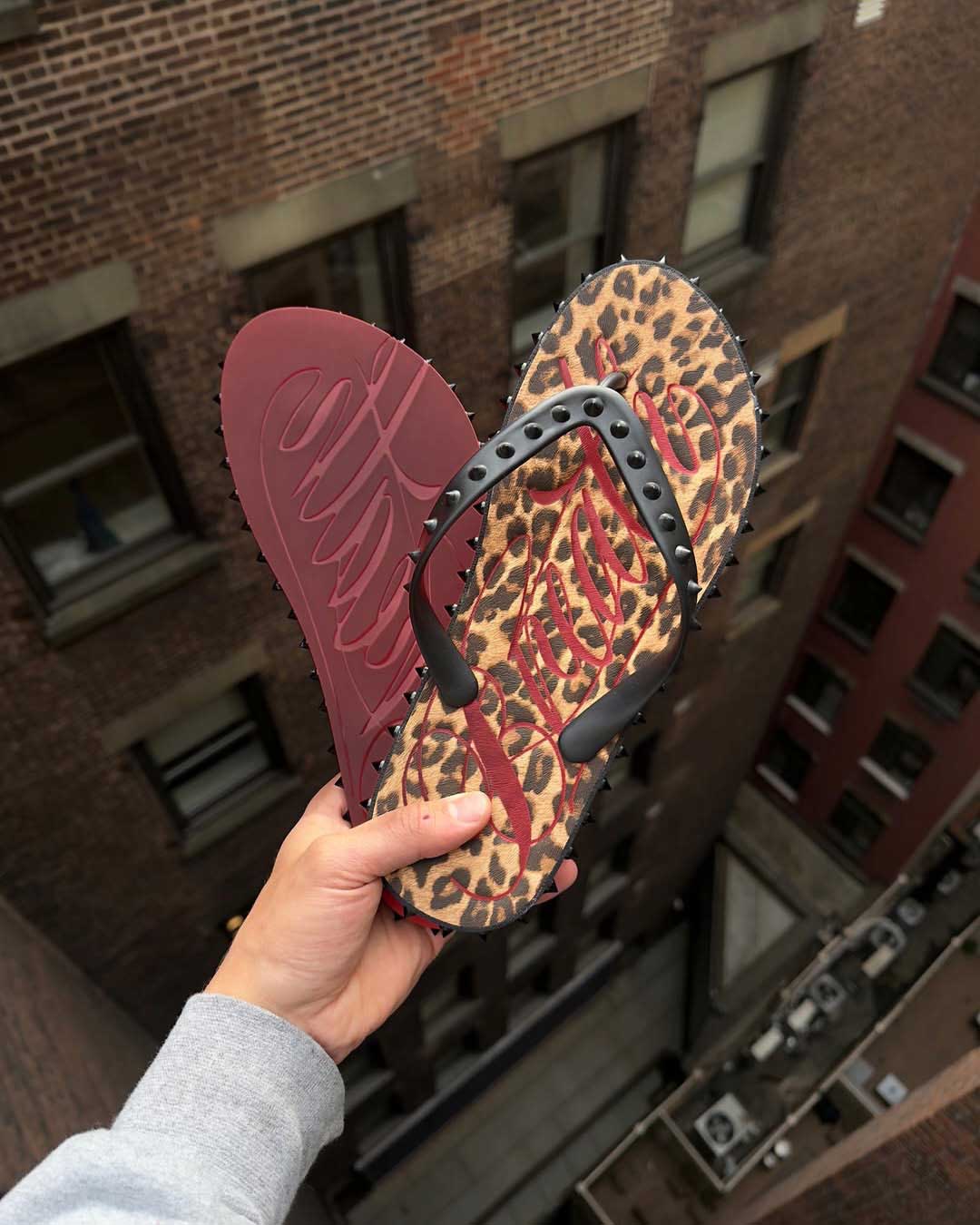 Bravest Studios Breathe Studded Flip Flops Leopard Print, held in hand showing the studded toe post and strap detail