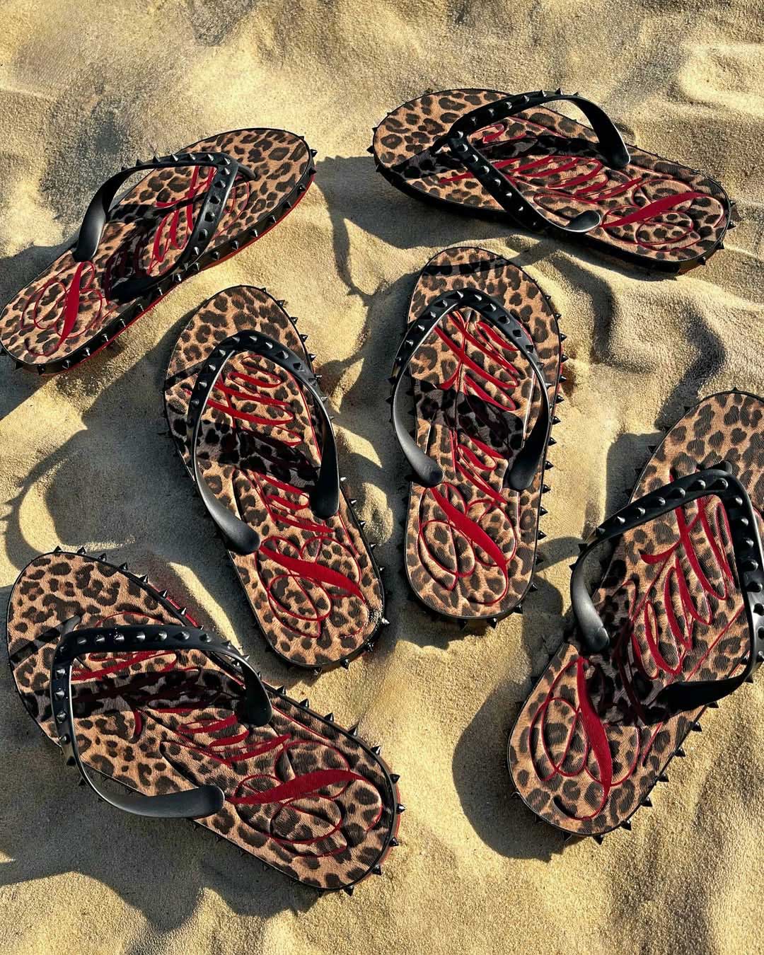 Bravest Studios Breathe Studded Flip Flops Leopard Print, worn on sand showing the leopard footbed and studded straps
