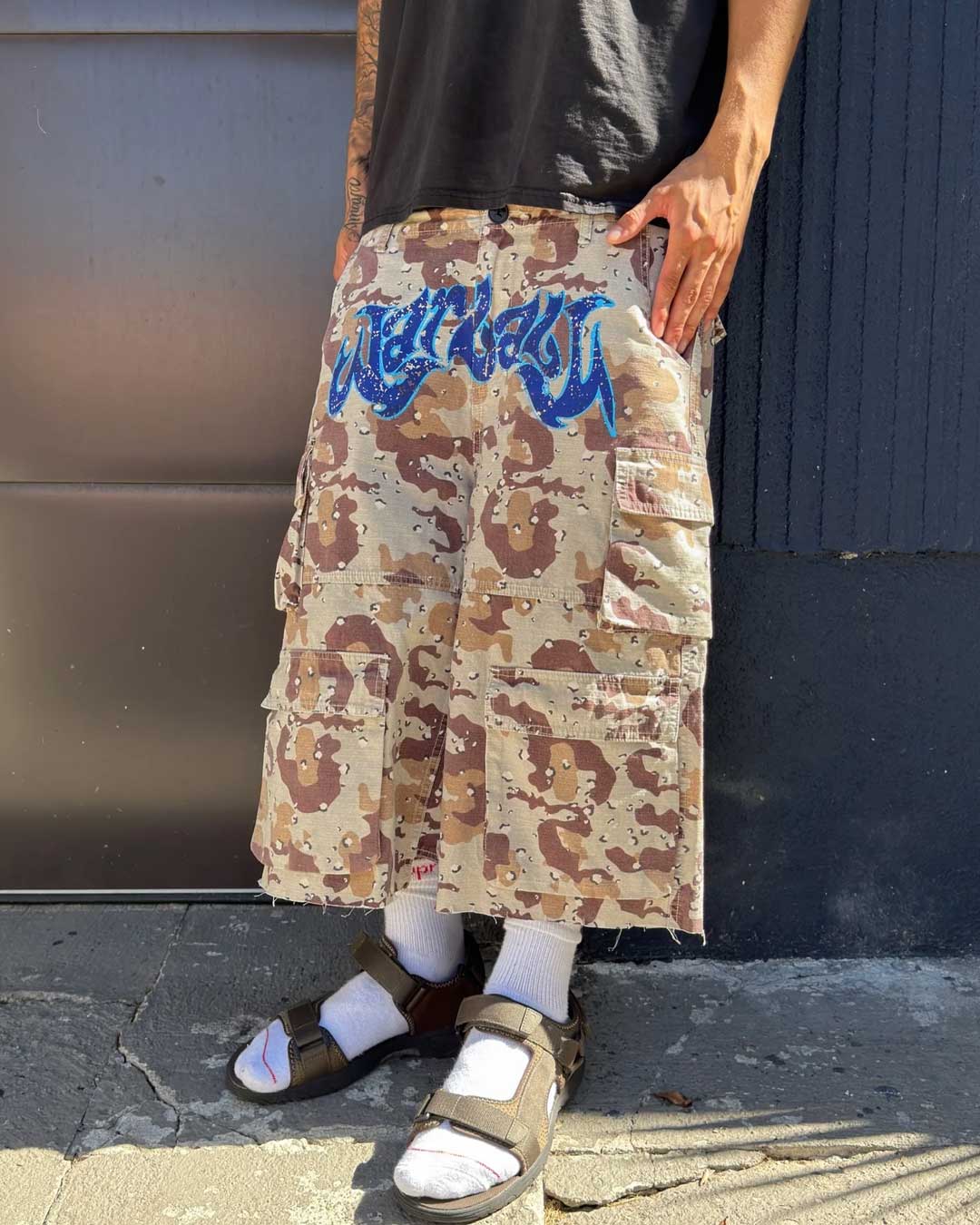 Bravest Studios Chip Camo War Baby Camo Shorts, model shot showing the extra-wide below-the-knee fit and flap cargo pockets
