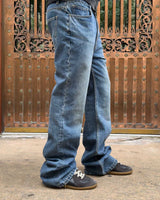Bravest Studios Flare Denim Pants blue, close model shot of the flared leg stacking over the shoe