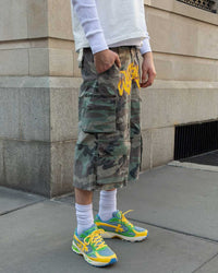 Bravest Studios Kross Kountry Runner Brazil, worn with camo cargo shorts and white crew socks, cropped street view
