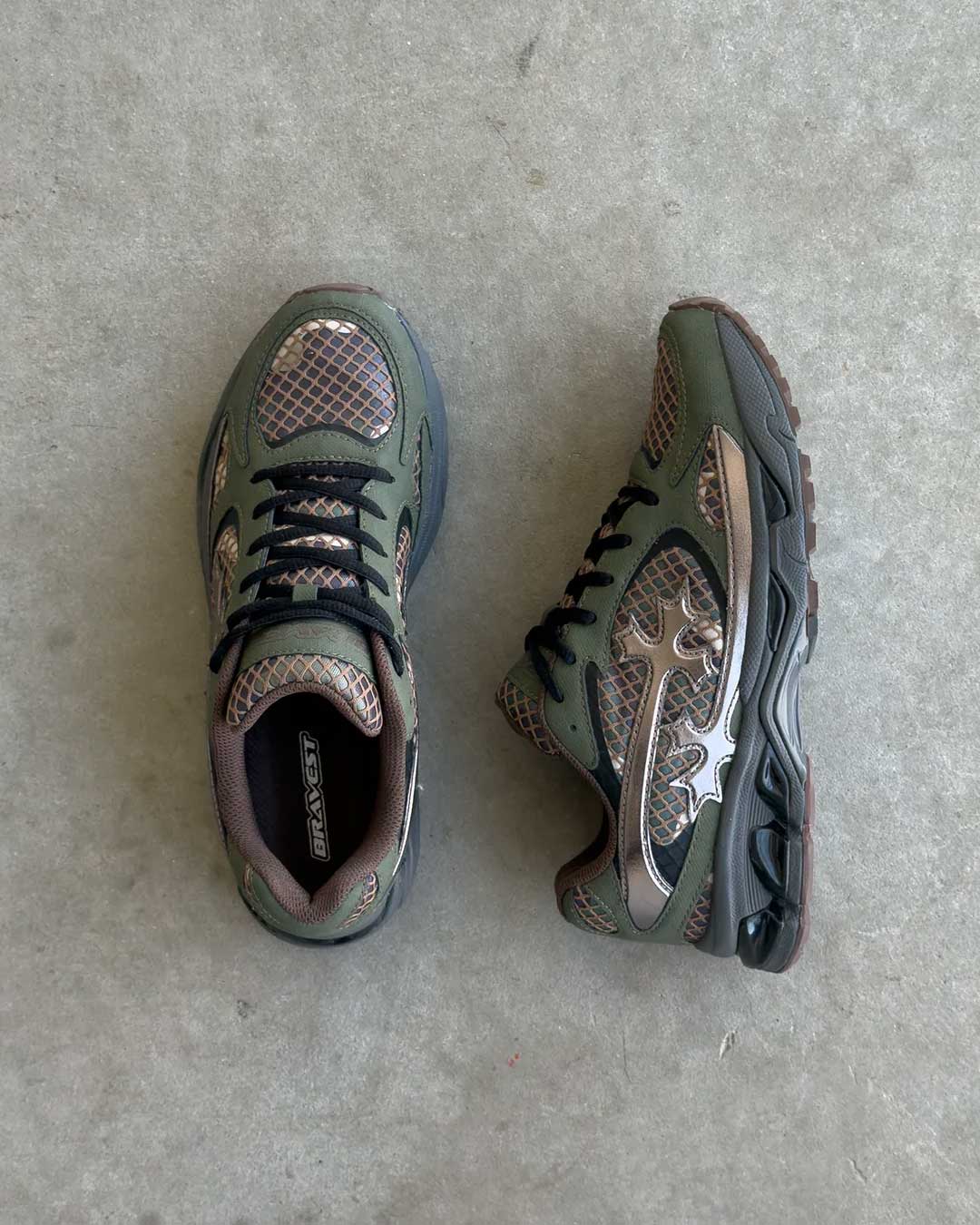 Bravest Studios Kross Kountry Runner Camo, top-down and side view on concrete showing the black laces and camo mesh panels
