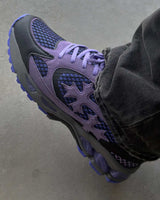 Bravest Studios Kross Kountry Runner Dirty Soda Purple, close-up of the lavender suede cross applique and lilac outsole