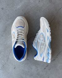 Bravest Studios Kross Kountry Runner Ice Blue, pair on concrete showing the royal blue collar lining and powder-blue overlays