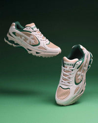 Bravest Studios Kross Kountry Runner Spring Green, pair floating on a green backdrop showing the kelly green overlays and tan mesh panels