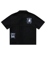 Bravest Studios Patch Polo black, back view showing two stitched-on photo patches