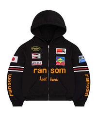 Bravest Studios Ransom Zip Up Hoodie black, moto-racing zip hoodie with embroidered sponsor patches and orange ransom lettering, front view