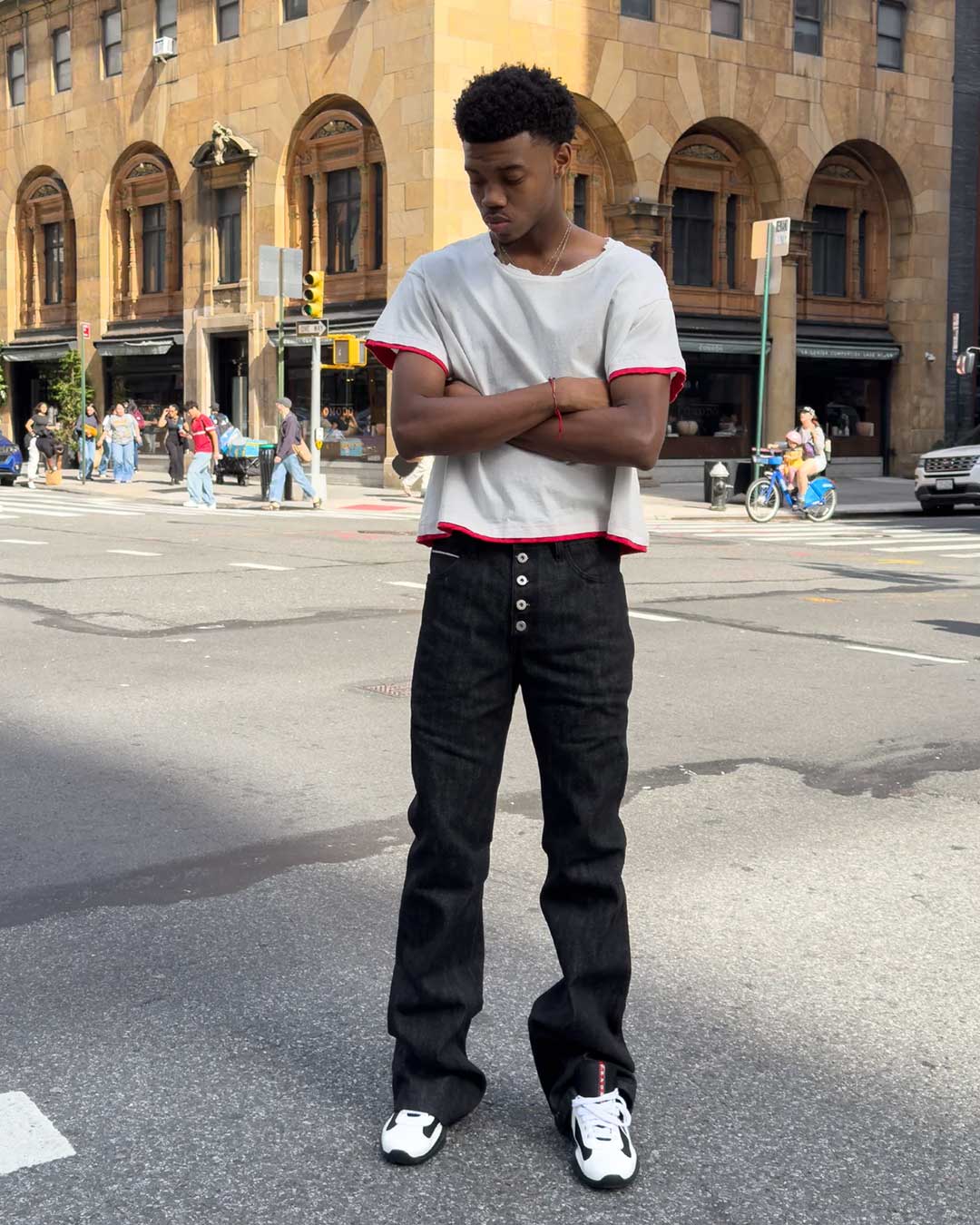 Bravest Studios Raw Flare Denim black, worn by a model with a white ringer tee, full-length street view