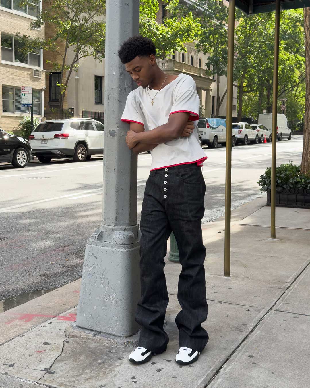 Bravest Studios Raw Flare Denim black, side-on model shot showing the flare and raw hem length