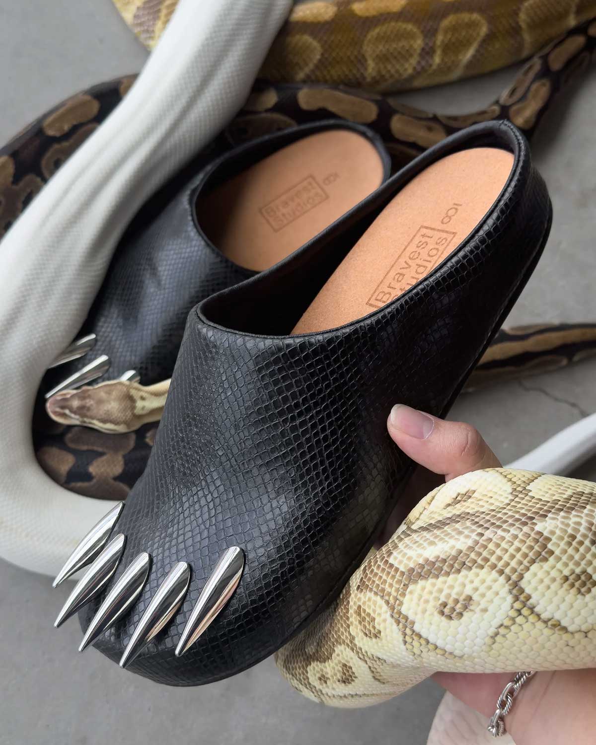 Bravest Studios Snake Claw Mule black snake-textured with chrome claw detailing, snakes in background