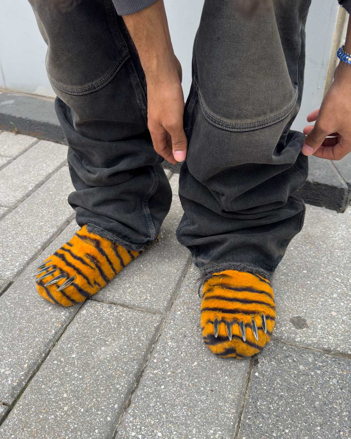 Bravest x Glo Gang Tiger Bear Claw Mule orange with black stripes and chrome claws, close up model