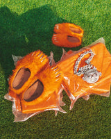 Bravest x Glogang Bear Claw Mule orange with chrome claw detailing, outside on grass