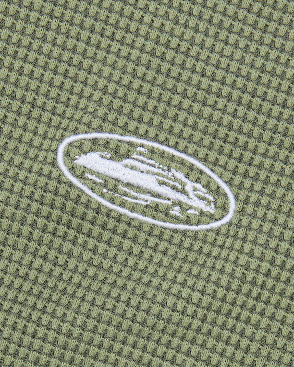Corteiz HMP Classic Tank Top olive, close-up of the embroidered white Alcatraz Island oval on the waffle knit