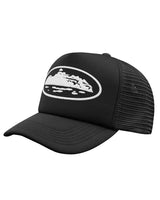 Corteiz Island Puff Print Trucker Hat black, foam-front mesh-back trucker cap with raised white puff-print Alcatraz Island graphic, three-quarter front view