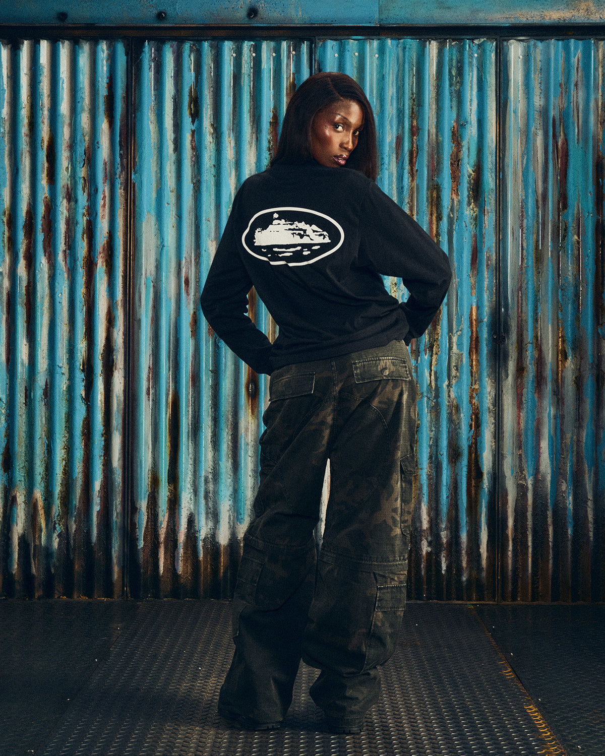 Corteiz OG Island LS Tee black, worn by a model, back view showing the large white Alcatraz Island oval