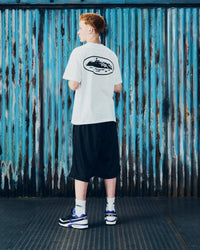 Corteiz OG Island Tee white, worn by a model, back view showing the large black Alcatraz Island oval