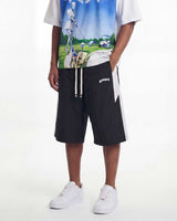 A model wearing black athletic shorts with white side stripes and a white graphic t-shirt, standing against a plain white studio background.