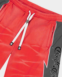 Godspeed Halftime Shorts V2 Red Acid Wash, side view showing the lightning-bolt panel seam and gothic script
