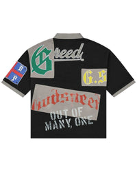 Godspeed Heritage Patchwork Polo black, back view with green G crest and patchwork lettering