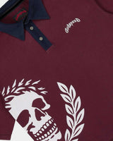 Godspeed Oversized Victor Crest Polo burgundy and navy, close-up of the skull crest and the Godspeed chest script