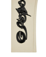 Godspeed Raw Import Sweatsuit bone/black, close-up of the black graffiti print down the pant leg