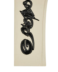 Godspeed Raw Import Sweatsuit bone/black, close-up of the black graffiti print down the pant leg