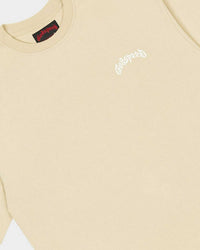 Godspeed Vital Necessi Tee oat milk, close-up of the arched blackletter Godspeed chest wordmark