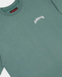 Godspeed Vital Necessi Tee sage smoke, close-up of the arched blackletter Godspeed chest wordmark