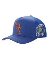 Godspeed x The Legacy Trucker Hat blue/orange, side view showing the New York patch and brim script