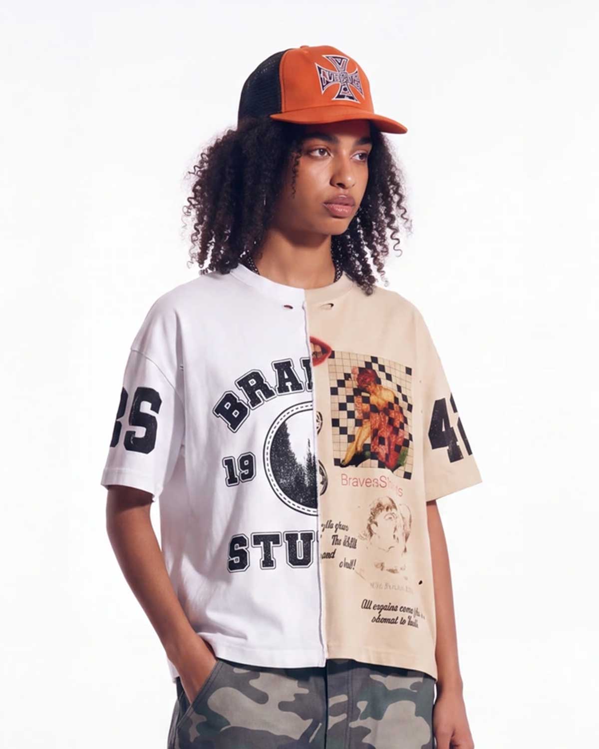 HMDD Orange Coast Trucker black and orange, worn on model with a split-panel varsity tee, upper body view