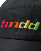 HMDD Runners Cap black, close-up of the embroidered rainbow gradient hmdd wordmark