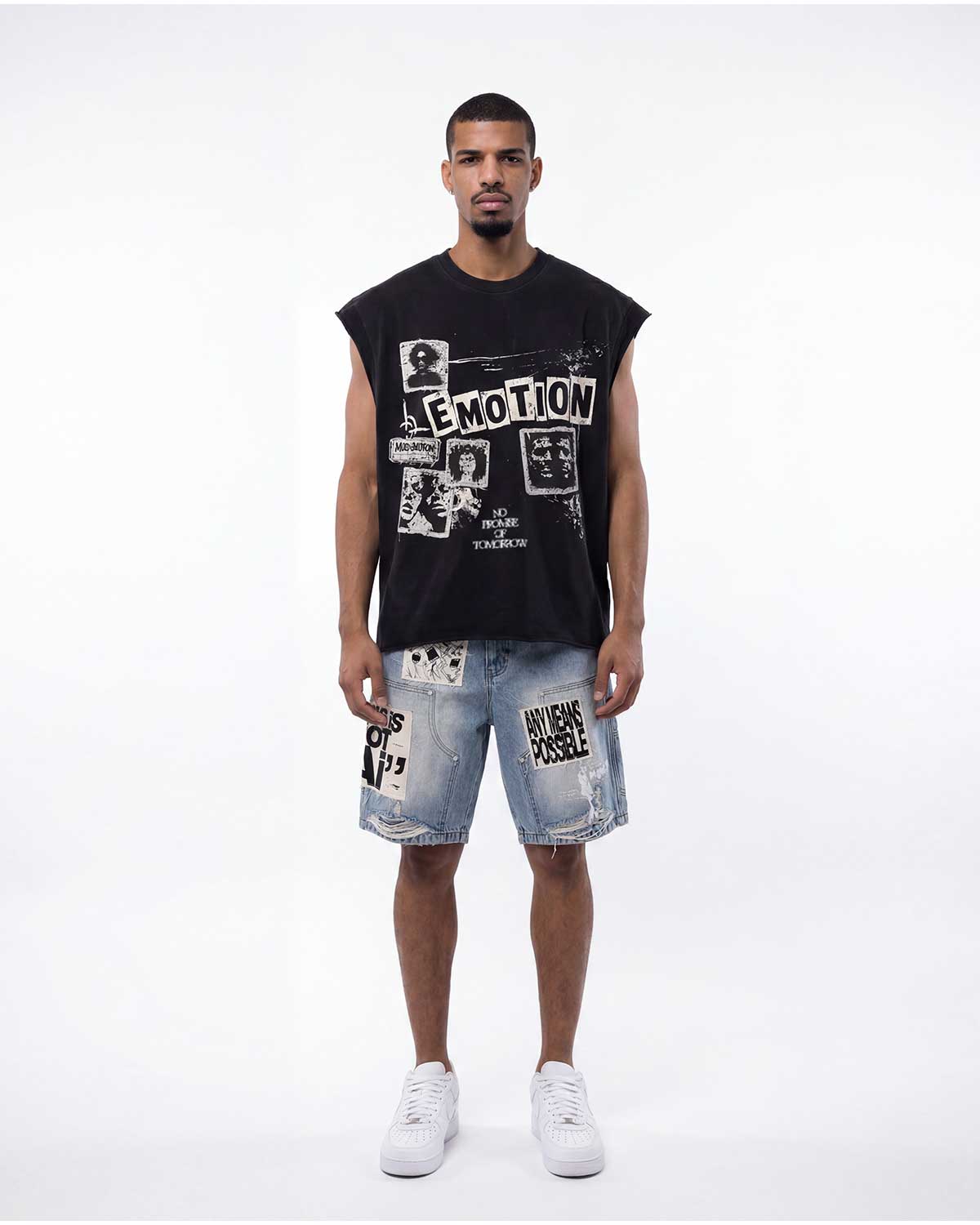 Model wearing Mixed Emotions Newspaper Sleeveless Tee black with patchwork denim shorts, full front view